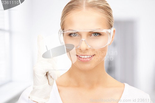 Image of woman in protective glasses and gloves