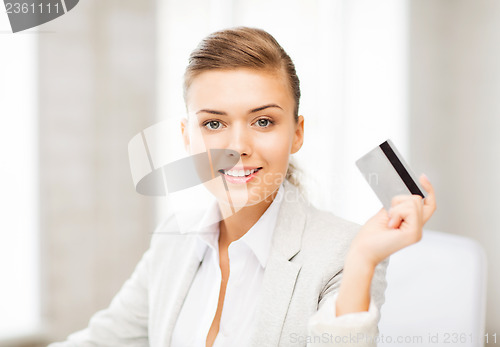 Image of smiling businesswoman showing credit card