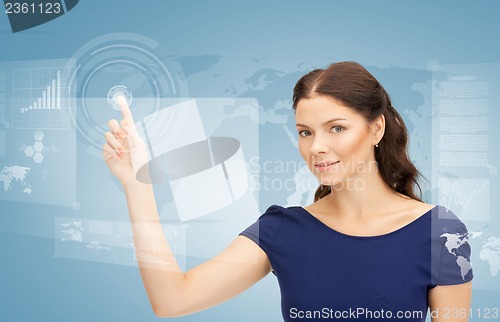 Image of businesswoman touching virtual screen