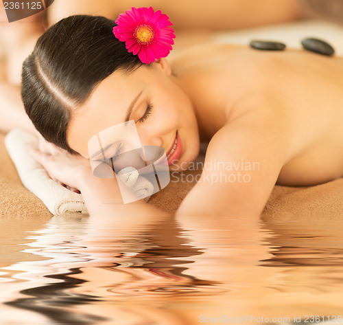 Image of woman in spa with hot stones