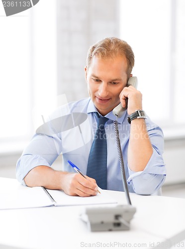 Image of handsome businessman talking on the phone