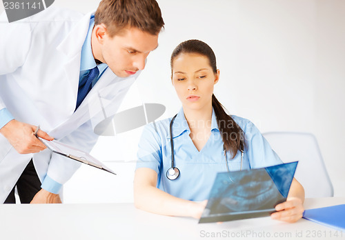 Image of two medical workers looking at x-ray