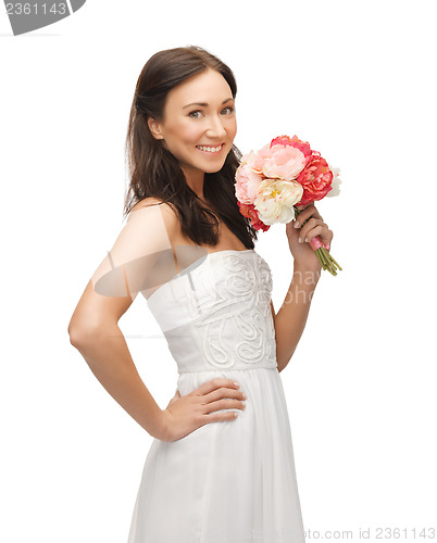 Image of woman smelling bouquet of flowers