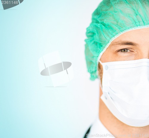 Image of surgeon in medical cap and mask