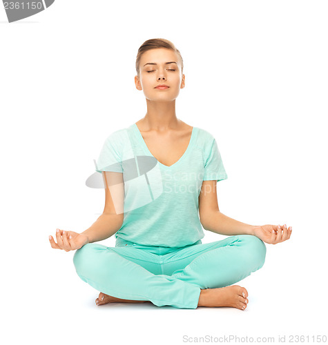 Image of girl sitting in lotus position and meditating