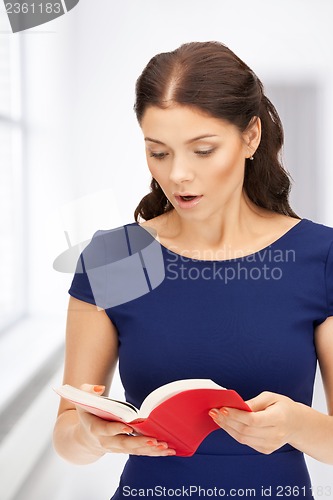 Image of surprised woman with book
