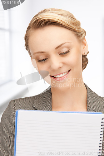 Image of happy woman with big notepad