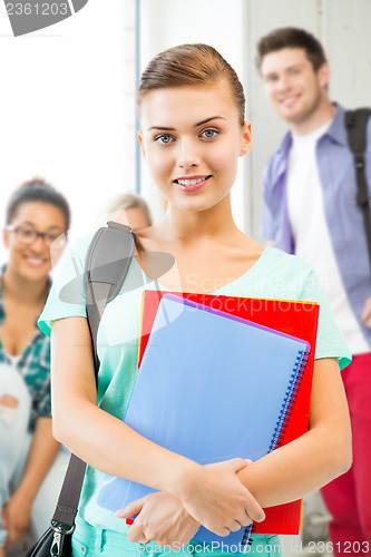Image of student girl with school bag and notebooks