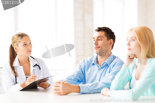 Image of doctor with patients in cabinet