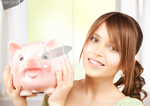 Image of lovely girl with big piggy bank