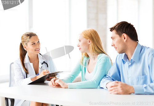 Image of doctor with patients in cabinet