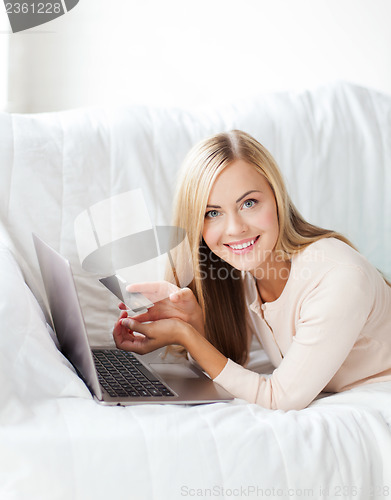 Image of businesswoman with laptop and credit card