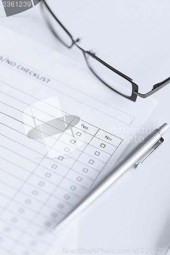 Image of blank questionnaire or form with eyeglasses