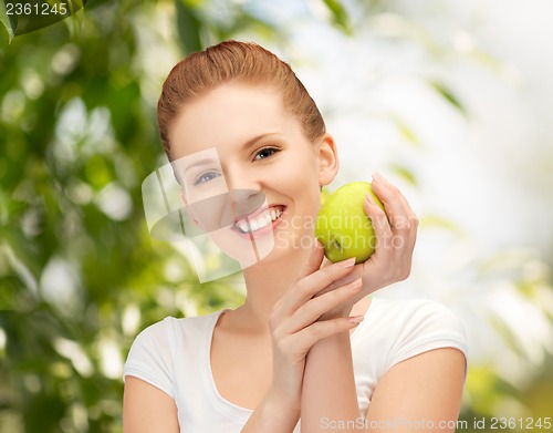 Image of young beautiful woman with green apple