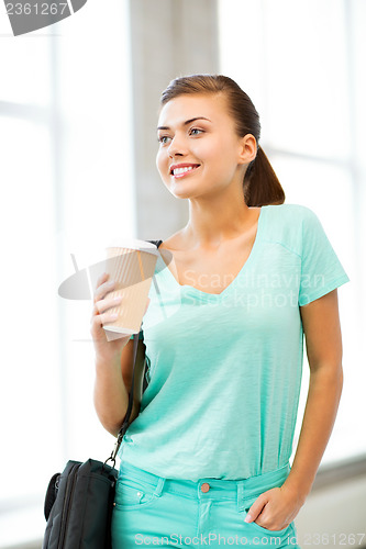 Image of student holding take away coffee cup