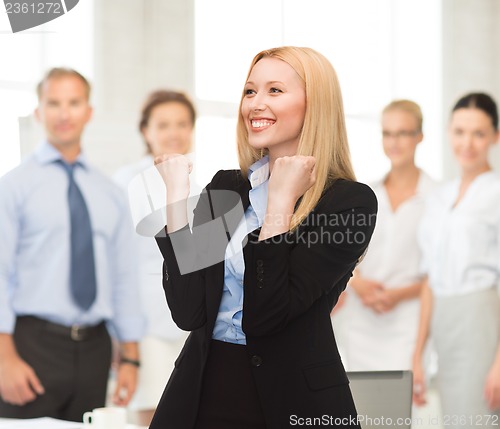 Image of happy woman with hands up