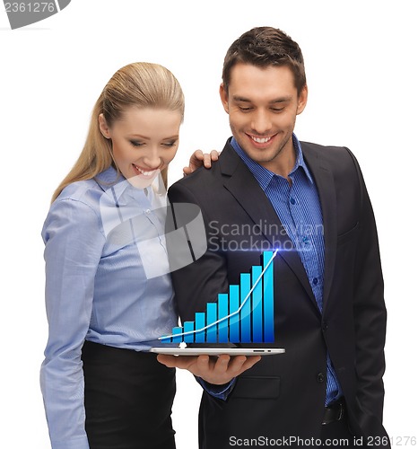 Image of two business people showing tablet pc with graph