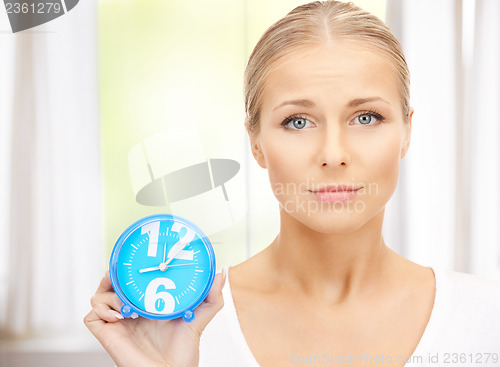 Image of woman holding alarm clock