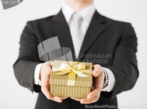 Image of man hands holding gift box