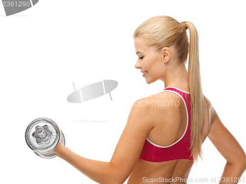 Image of woman with heavy steel dumbbell