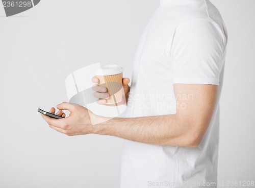 Image of man with smartphone and coffee