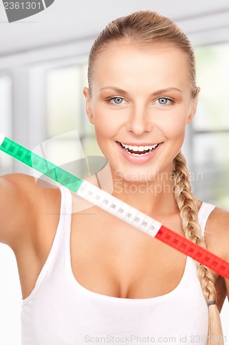 Image of young beautiful woman with measure tape