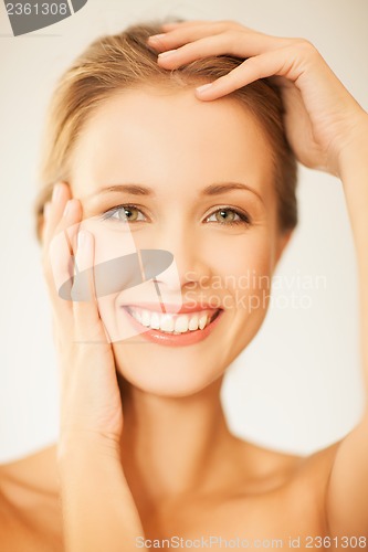 Image of woman touching her face