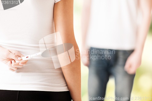 Image of woman hiding pregnancy test