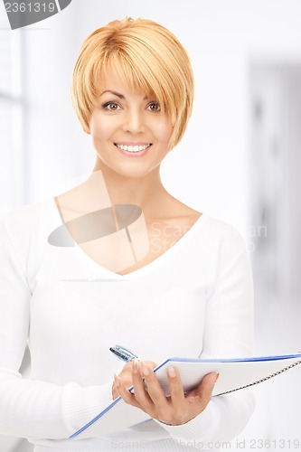 Image of attractive businesswoman with notebook