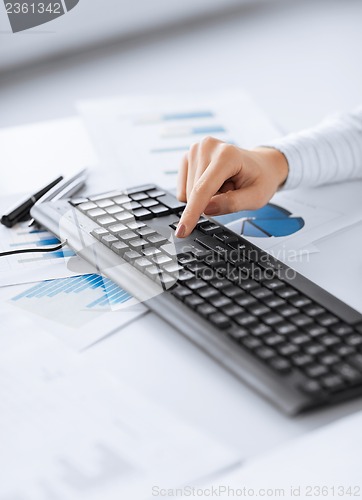 Image of woman hand pressing enter button on keyboard