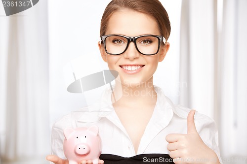 Image of lovely woman with piggy bank