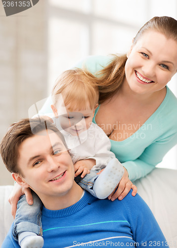 Image of happy parents playing with adorable baby