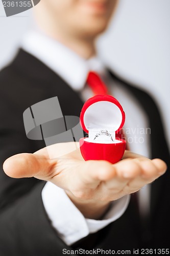 Image of man with wedding ring and gift box