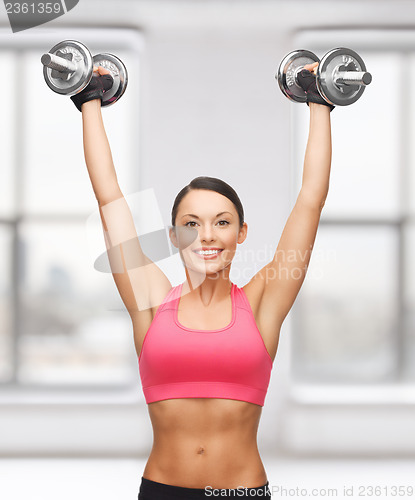 Image of woman with heavy steel dumbbells