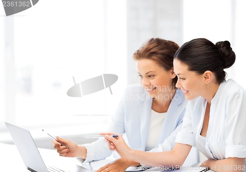 Image of businesswomen working with laptop in office