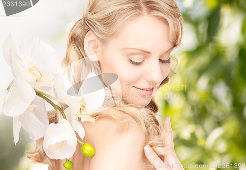 Image of beautiful woman with orchid flower