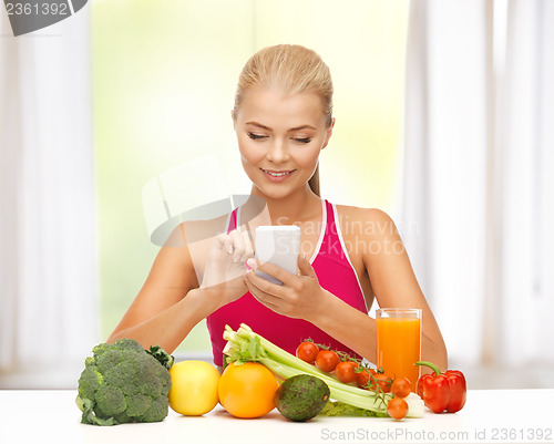 Image of woman with fruits, vegetables and smartphone
