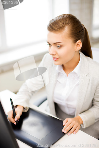 Image of businesswoman with drawing tablet in office