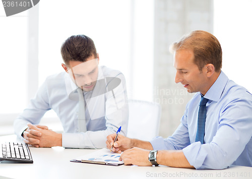 Image of businessmen with notebook on meeting