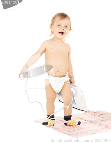 Image of baby plugging in iron