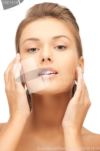Image of woman touching her face