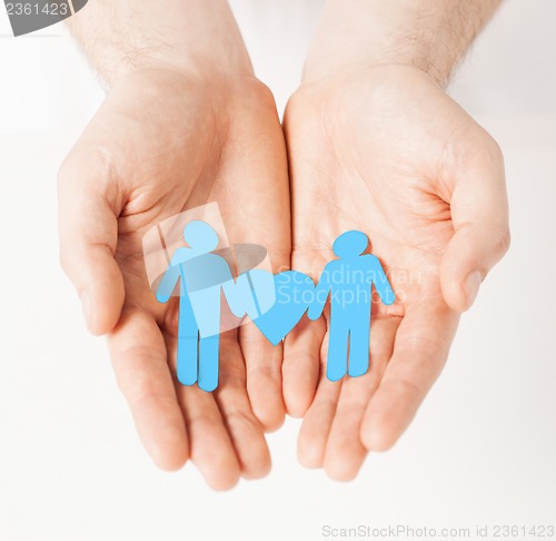 Image of man hands with paper men