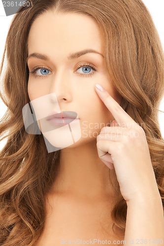 Image of woman pointing at her eye area