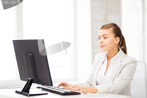 Image of businesswoman with computer in office