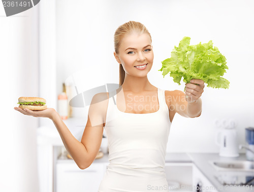 Image of woman with green leaves and hamburger