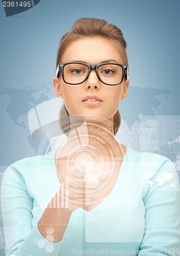 Image of businesswoman pointing at virtual screen