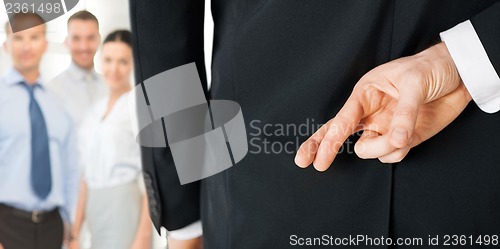 Image of man with crossed fingers