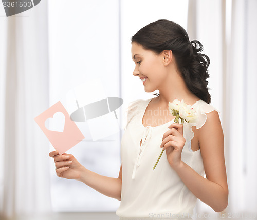 Image of young woman holding flower and postcard