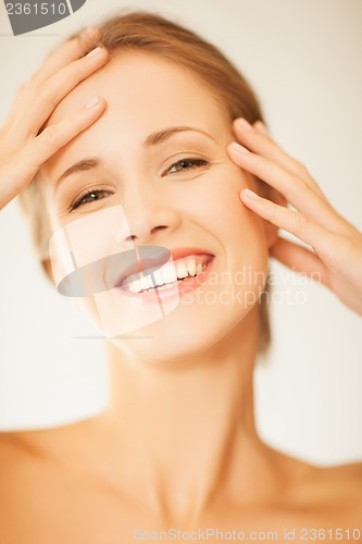Image of woman touching her face