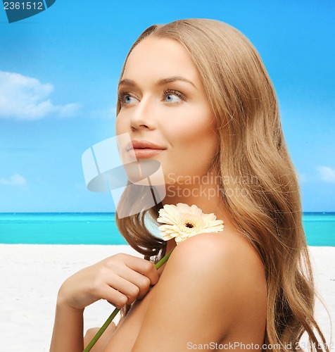 Image of lovely woman with gerbera flower